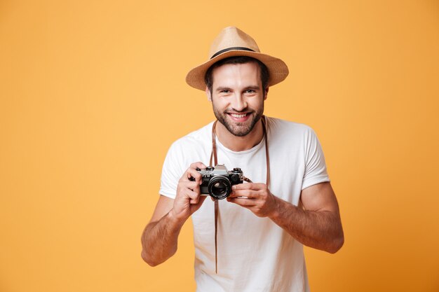 Horizontal image of a positive man holding camera
