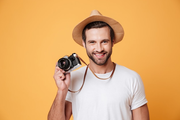 Horizontal image of a positive man holding camera