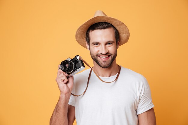 Horizontal image of a positive man holding camera