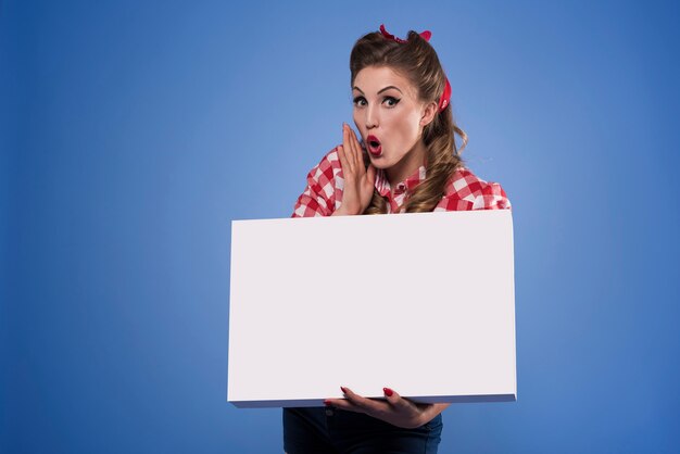 Horizontal placard held by pin up woman