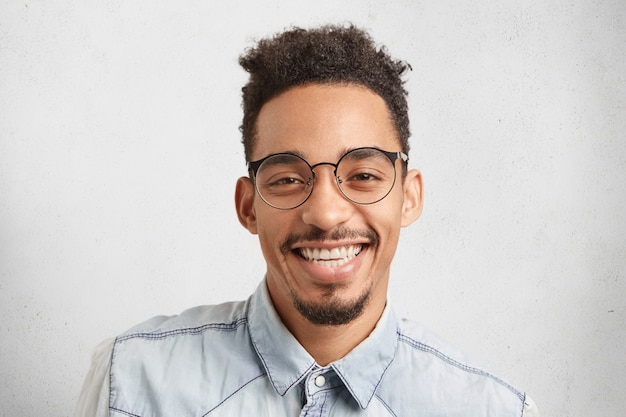 Horizontal portrait of happy male enterpreneur being glad to succeed