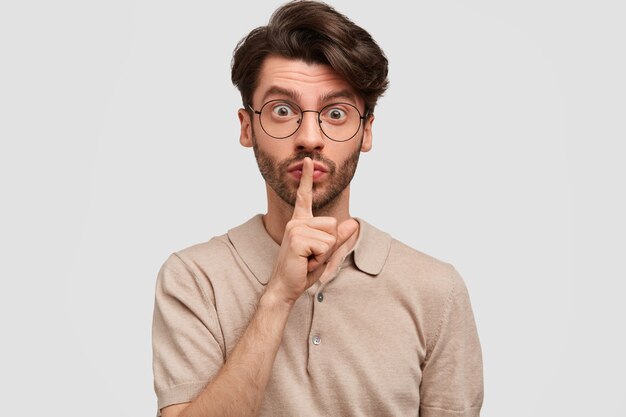 Horizontal shot of attractive unshaven male with pleasant appearance