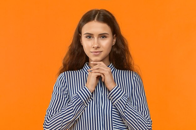 Horizontal shot of charming cute young european female with neat make up