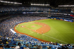 Horizontal shot of crowded yankee baseball stadium and players in the field