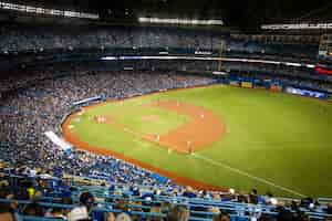 Free photo horizontal shot of crowded yankee baseball stadium and players in the field