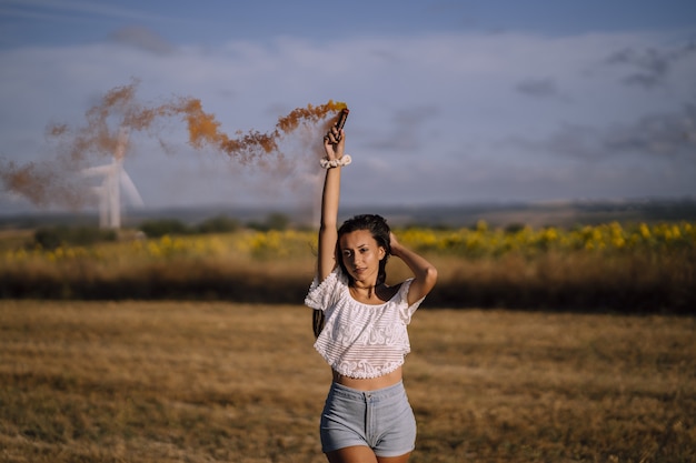 Free photo horizontal shot of a female posing with a smoke bomb