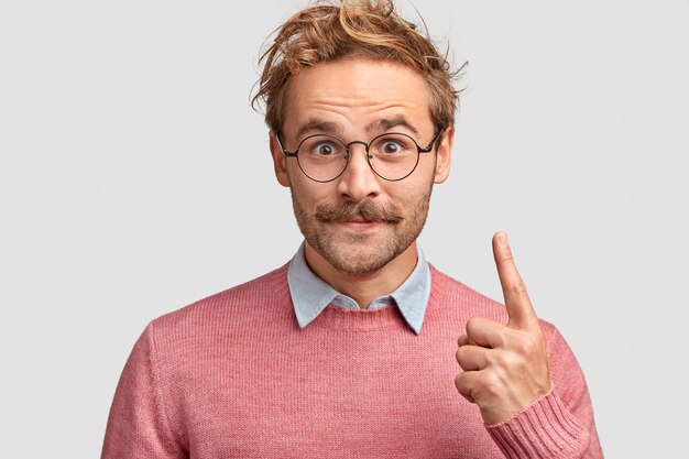 Free photo horizontal shot of handsome satisfied hipster has moustache, dressed in elegant clothes