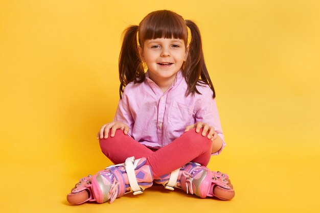 Horizontal shot of happy smiling girl wearing casually