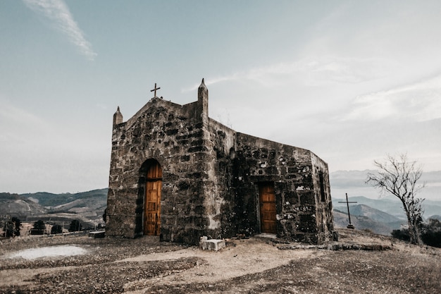 Horizontal shot of an old small church on a mountain