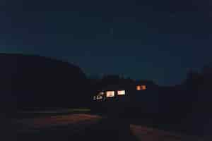 Free photo horizontal shot of a white vehicle with lights under the beautiful starry sky at night time