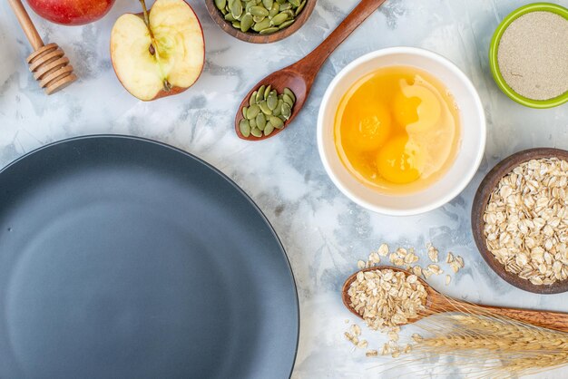 Horizontal view of black plate and ingredients for the healthy food set on ice background