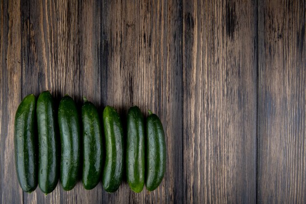 Horizontal view of cucumbers on wooden surface with copy space