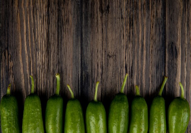 Horizontal view of cucumbers on wooden surface with copy space