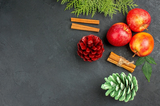 Vista orizzontale di mele fresche cannella lime e accessori per la decorazione su sfondo nero