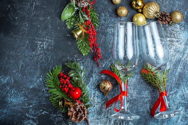 Horizontal view of glass goblets decoration accessories on the left side on dark background