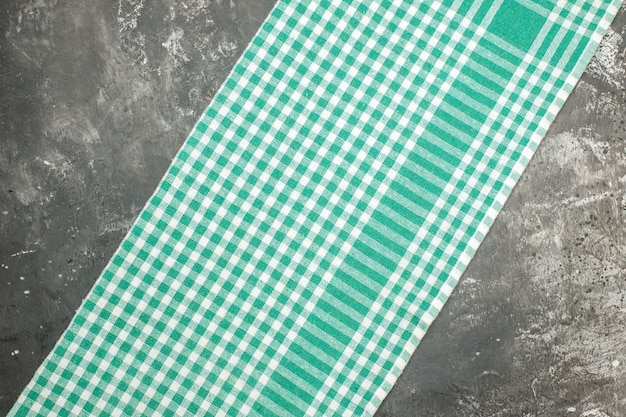 Horizontal view of green striped towel on gray table