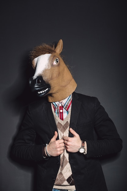 Free photo horse mask man in studio