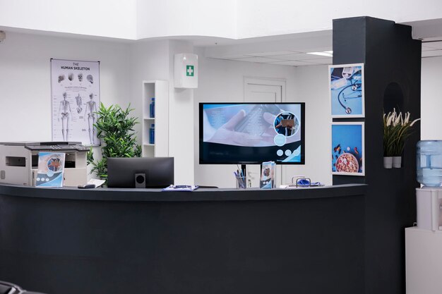 Hospital reception desk with computer, making healthcare appointments for patients with disease. Registration work with medical checkup reports and papers forms in facility lobby.