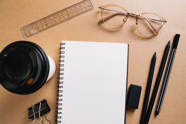 Hot beverage and glasses near stationery