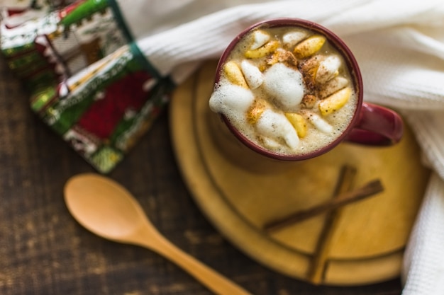 Hot chocolate and cinnamon near towel and spoon