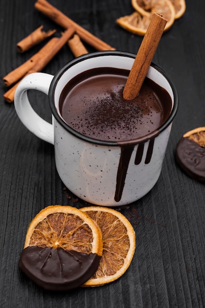 Hot chocolate with cinnamon stick and dried orange slices