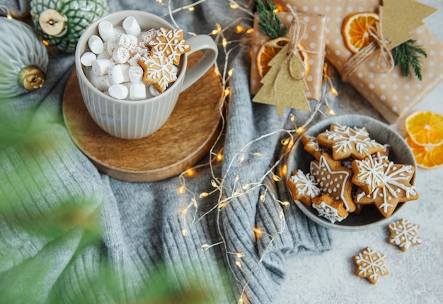 Hot chocolate with marshmallows, warm cozy christmas drink, gingerbread cookies and decorations
