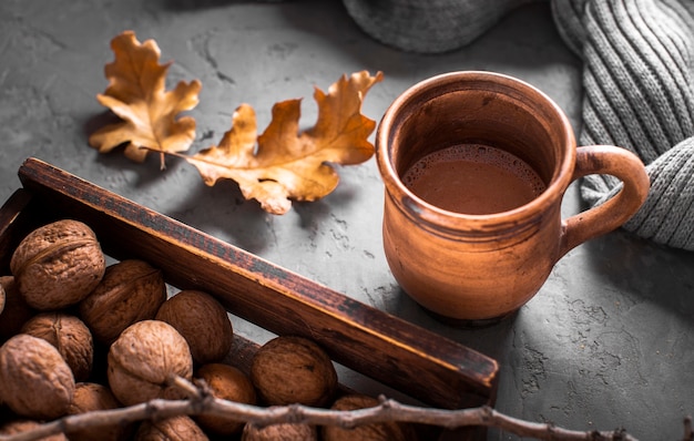 Free photo hot chocolate with walnuts  and leaves