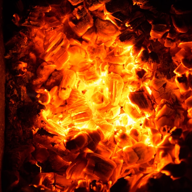Hot coals in the fire. Abstract background of burning ember.