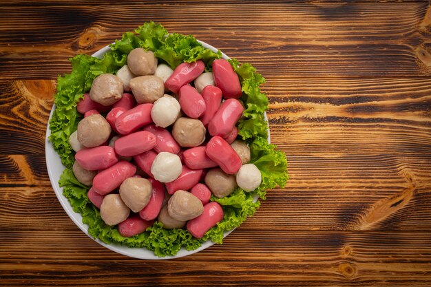 Hot dog or sausages on the dark wooden surface.