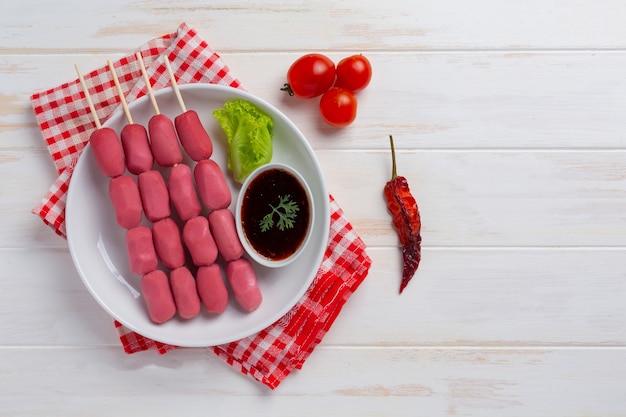 Hot dog or sausages on the white wooden surface.