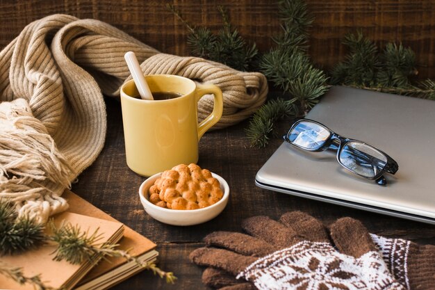 Hot drink near warm accessories and laptop