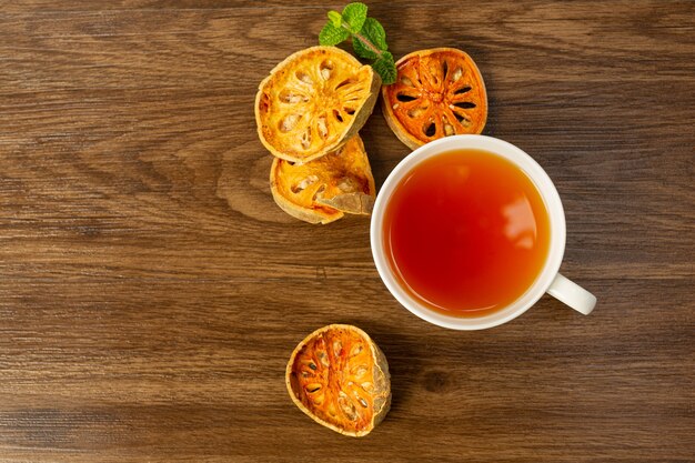 Hot dry bael fruit tea in a Thai herbal cup