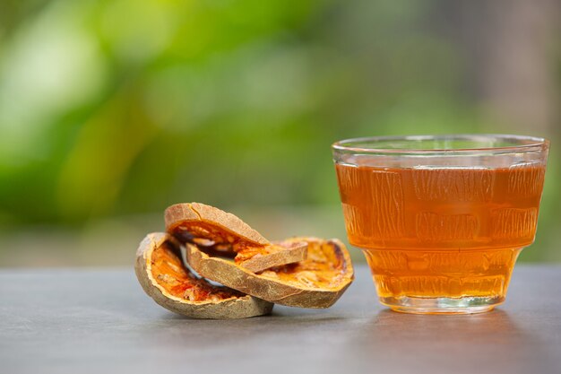 Hot dry bael fruit tea in a Thai herbal cup