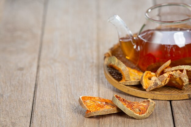 Hot dry bael fruit tea in a Thai herbal cup