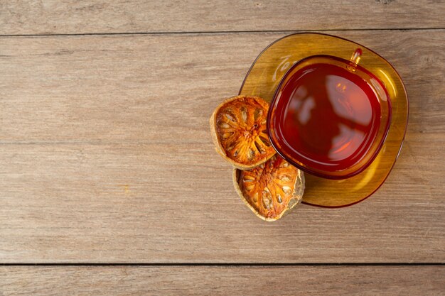 Hot dry bael fruit tea in a Thai herbal cup