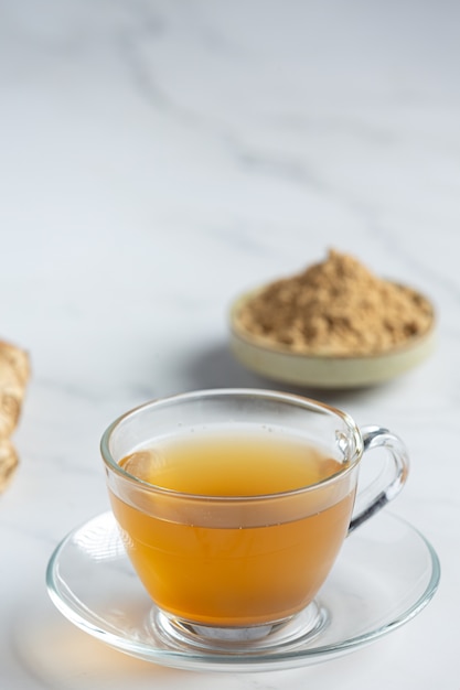 Hot ginger tea on table