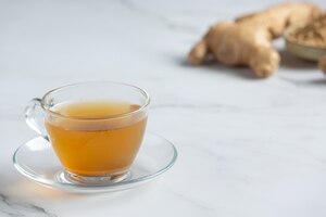Hot ginger tea on table