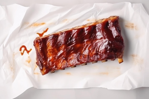 Free photo hot grilled spare ribs with barbecue sauce on crumpled paper top view ai generative