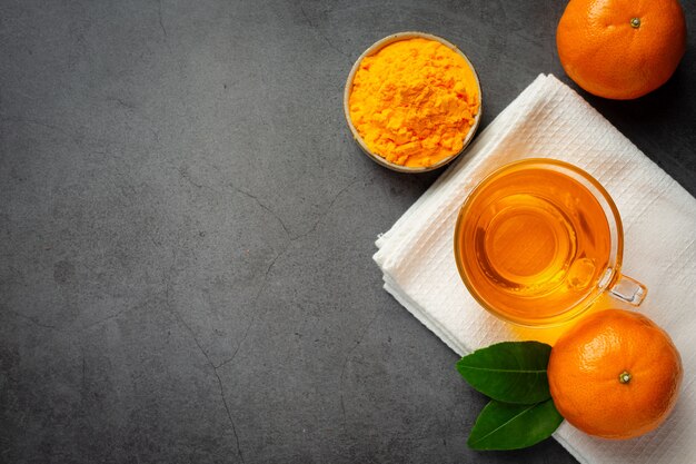 Hot orange tea and fresh orange on the table