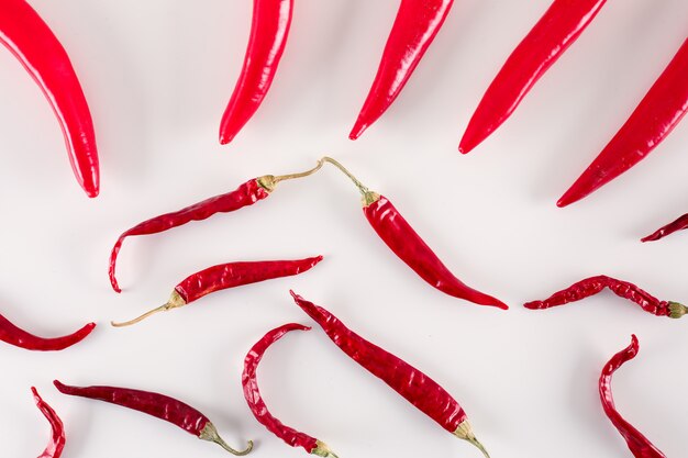 hot red chili peppers on white surface