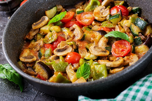 Hot spicy stew eggplant, sweet pepper, tomato, zucchini and mushrooms.