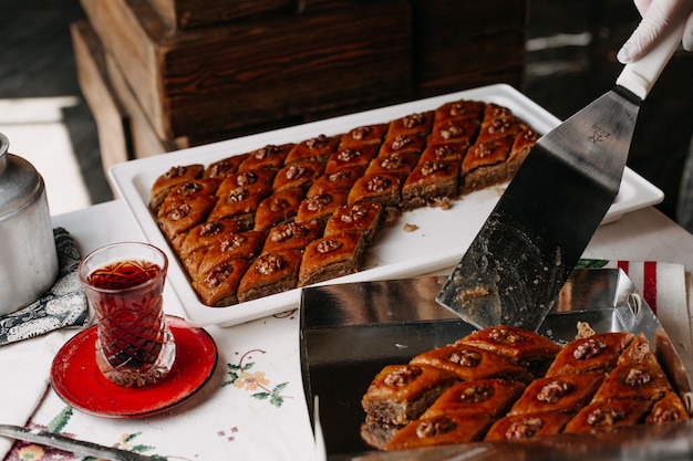 hot tea along with sweet pakhlavas on designed tissued table