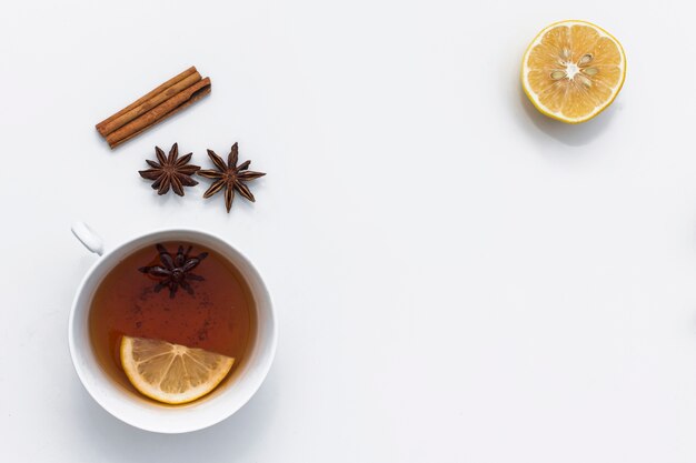 Hot tea cup with various ingredients