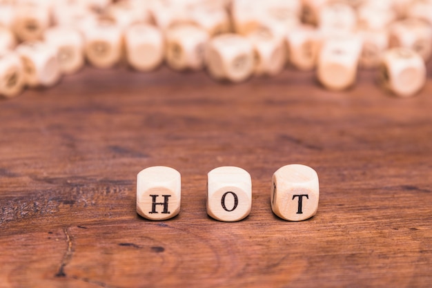 Free photo hot word arranged in row over wooden desk