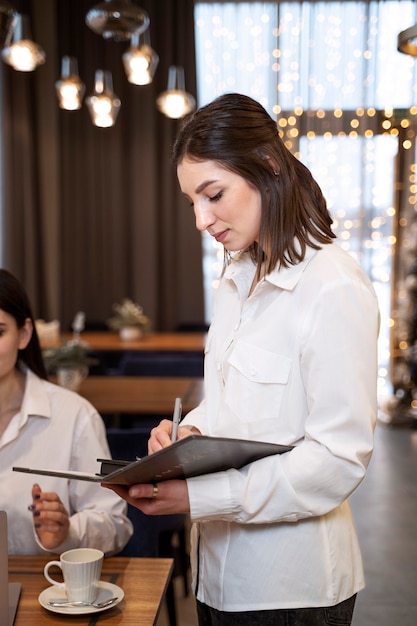 Hotel waiter taking order from customer