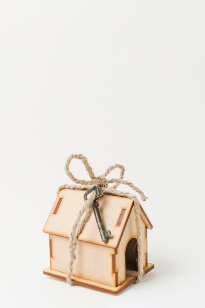 House as a gift with vintage key over white surface