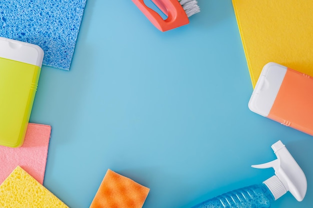 Free photo house cleaning products on blue background flat lay