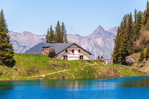 House in front of the Lac Lioson lake in Switzerland