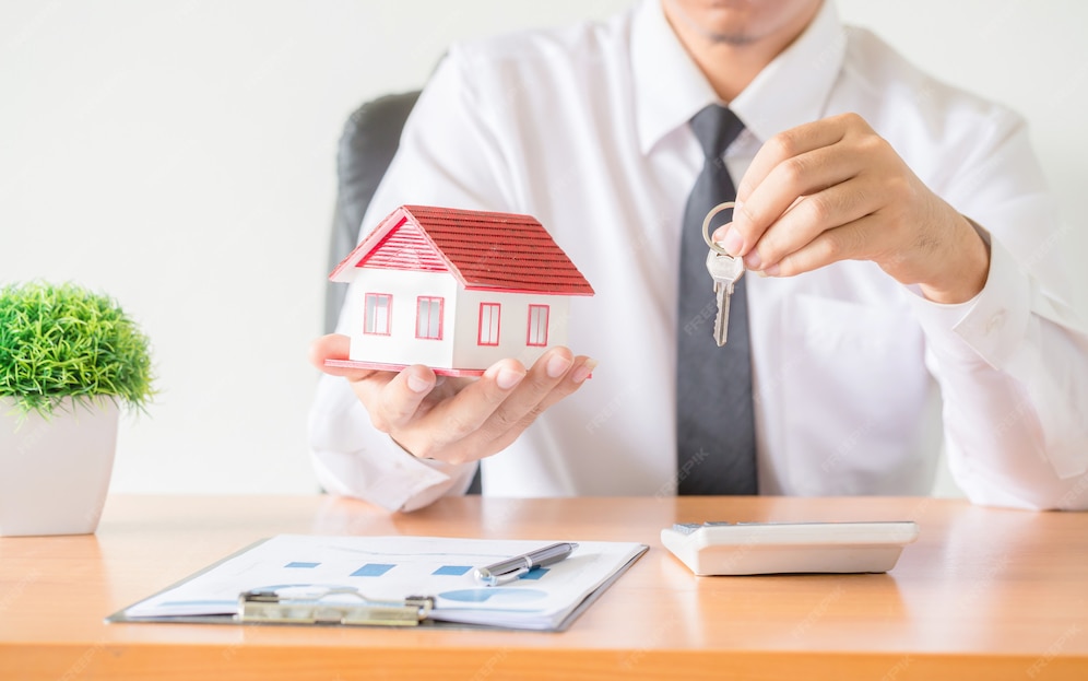 Money lender holding a miniature house