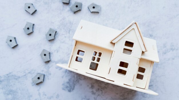 House model with many small bird houses on concrete background